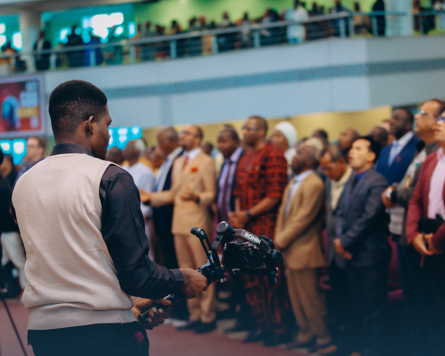 Isaiah operating a camera gimbal at a live event
